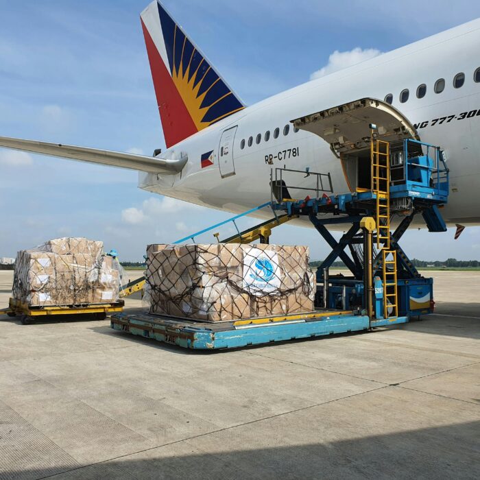 Cargo being loaded onto a commercial airplane at an airport in Ho Chi Minh City, Vietnam.